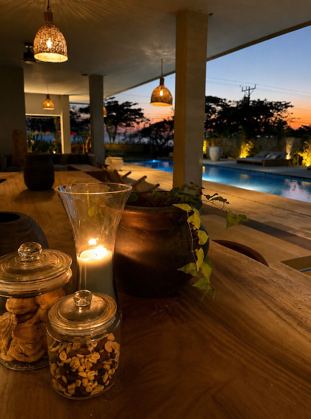 Candlelit table and pool at blue hour