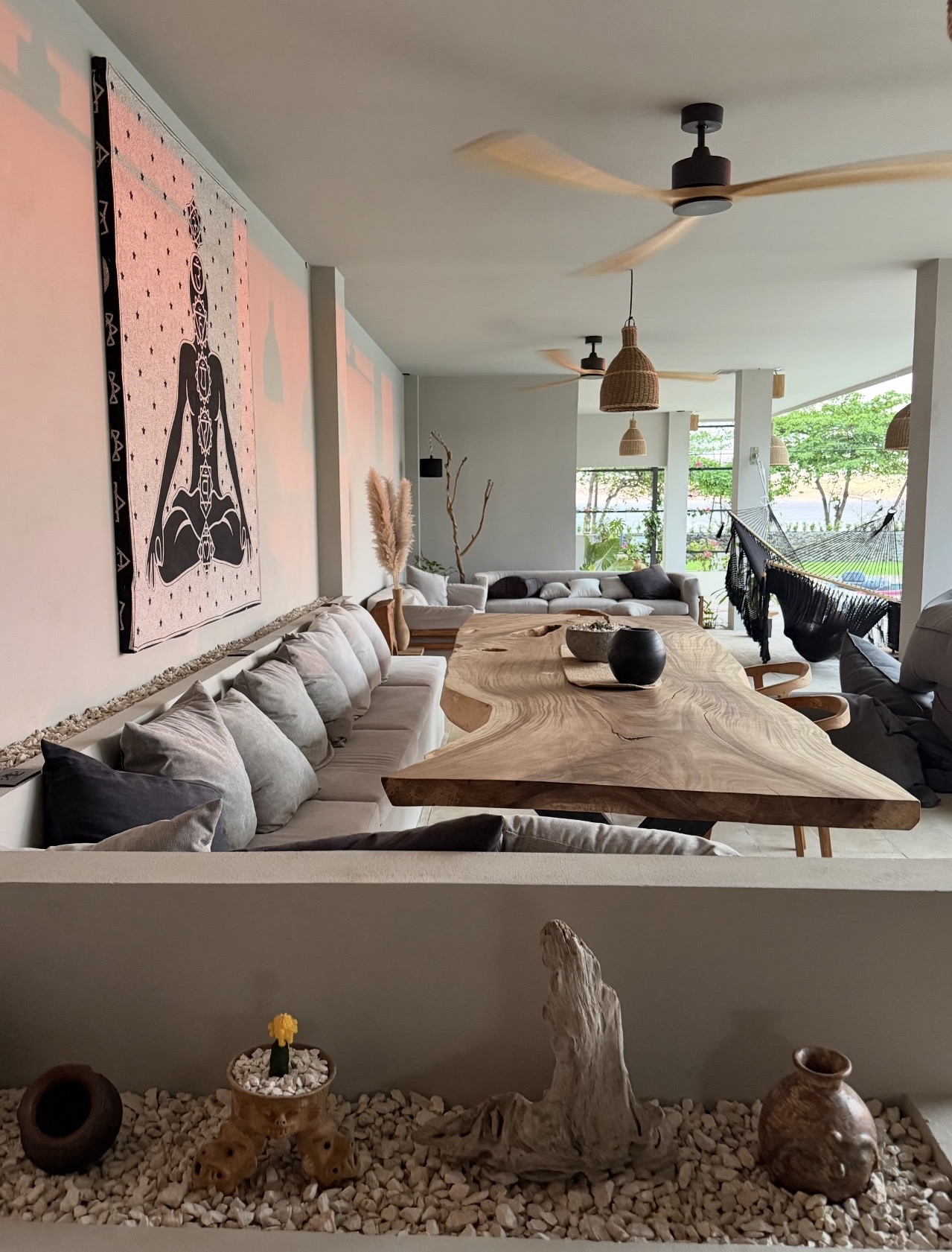 Communal live-edge dining table and open-air lounge at Selvamar